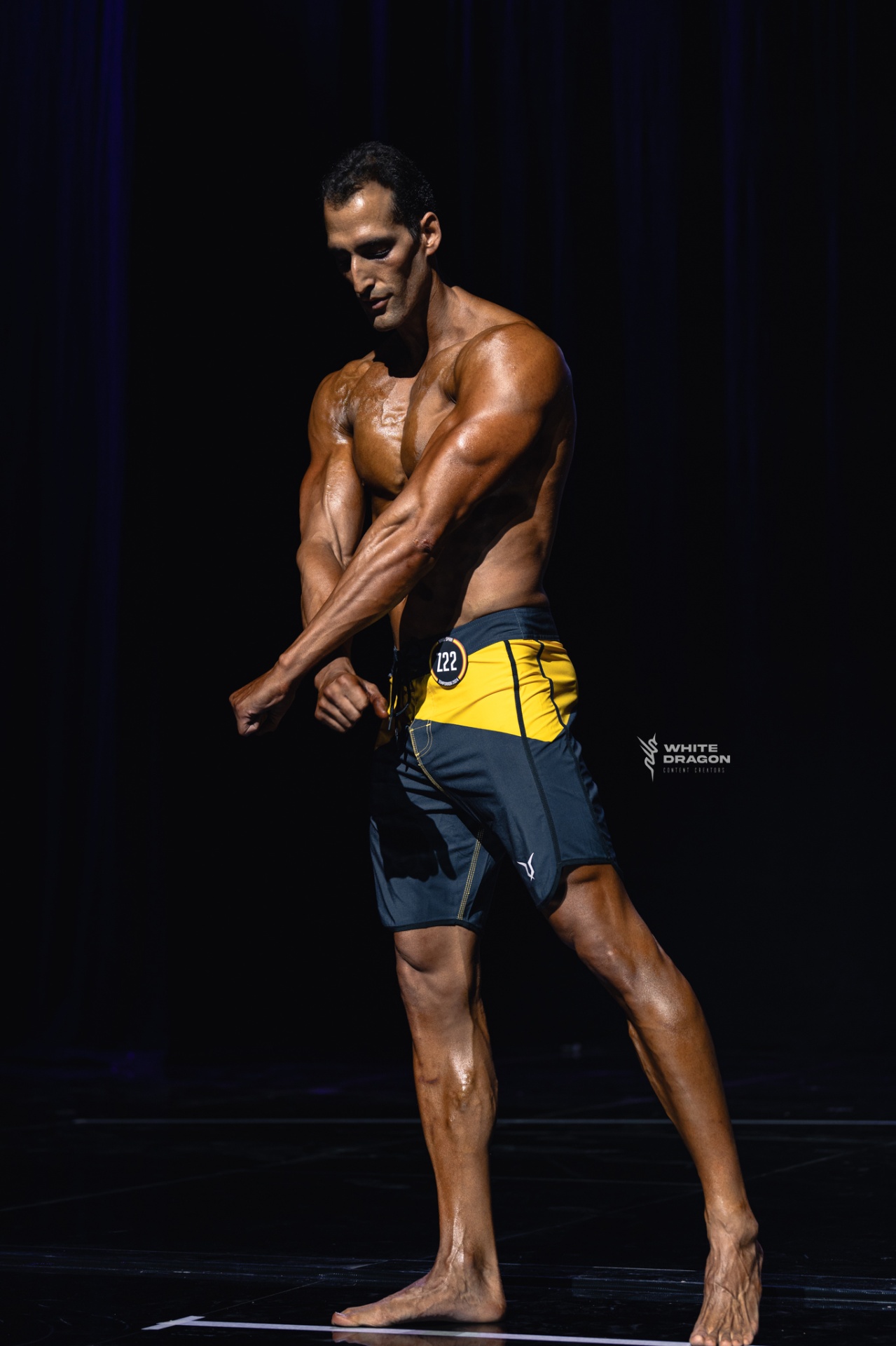 Coach Lou on stage — side pose